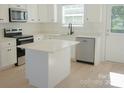 Well-lit kitchen boasting stainless steel appliances and a center island at 816 Fairview St # A, Kannapolis, NC 28083