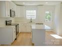 Charming white kitchen with stainless steel appliances and a bright window at 816 Fairview St # A, Kannapolis, NC 28083