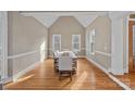 Elegant dining area featuring high ceilings, natural light, and hardwood floors at 888 Craigmont Nw Ln, Concord, NC 28027
