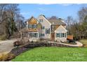 Well-manicured lawn and beautiful landscaping surround this charming traditional home at 888 Craigmont Nw Ln, Concord, NC 28027