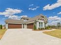 Spacious three-car garage and long driveway on a sunny day at 1010 Rolling Meadows Dr # Rm14, Mooresville, NC 28115