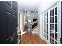 Inviting foyer with hardwood floors, transom windows, and glass french doors at 105 Millwood Dr, Fort Mill, SC 29715