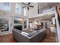 Spacious living room featuring tall windows, a fireplace, and an open floor plan at 105 Millwood Dr, Fort Mill, SC 29715
