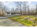 Attractive ranch style home featuring metal roof and a well-kept lawn, promising curb appeal at 1106 Forest Dr # 75, Marshville, NC 28103