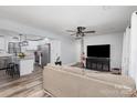 Bright, open-concept living room featuring modern ceiling fan and seamless flow into kitchen area at 1106 Forest Dr # 75, Marshville, NC 28103