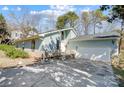 Charming single-Gathering home featuring light blue siding, stone accents, and an attached two-car garage at 1205 Molokai Dr, Tega Cay, SC 29708