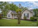 Inviting single-story home with a manicured lawn, classic siding, a carport, and a neatly landscaped front yard at 124 Woodside Ln, Lancaster, SC 29720