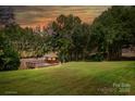 Beautiful backyard featuring a gazebo overlooking a large grassy lawn, and wooded area at 126 Emerald Dr, Mooresville, NC 28117