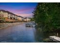 Beautiful waterfront view featuring a community boat dock, a walkway, and serene water at 126 Emerald Dr, Mooresville, NC 28117