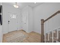 Inviting entryway with hardwood floors, a bright white door, and a staircase leading to the upper level at 14024 Felix Ln # 4, Charlotte, NC 28277