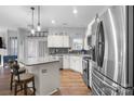 Modern kitchen with stainless steel appliances, granite counters, and a breakfast bar at 150 Harbor Cove Ln, Mooresville, NC 28117