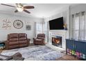 Cozy living room with a fireplace, comfortable seating, and natural light at 150 Harbor Cove Ln, Mooresville, NC 28117