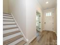 Bright entryway featuring hardwood floors, staircase and a front door with sidelights at 17025 Malone Ln, Mint Hill, NC 28227