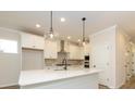 Stylish kitchen with white cabinets, quartz countertops, and stainless steel appliances at 17025 Malone Ln, Mint Hill, NC 28227