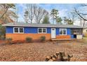Charming home with a blue exterior, red brick, screened in porch, and spacious front yard at 333 S Eastway Dr, Troutman, NC 28166
