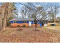 Charming home with a blue exterior, red brick, screened in porch, and spacious front yard at 333 S Eastway Dr, Troutman, NC 28166
