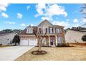 Beautiful two-story home featuring a stone facade, well-kept lawn, covered porch, and convenient three-car garage at 3563 Valiant Sw Ave, Concord, NC 28027