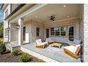 A comfortable covered patio with white-painted brick pillars, a ceiling fan, and outdoor furniture at 4004 Nettie Ct # 1, Charlotte, NC 28211