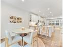 Bright dining area features a modern table, stylish chairs, and access to a kitchen area at 4010 Citra Ln, Charlotte, NC 28217