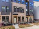 Beautiful townhome featuring a brick facade, dark trim, and a welcoming entrance with manicured landscaping at 4010 Citra Ln, Charlotte, NC 28217