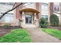 Welcoming entrance features a stone walkway, manicured landscaping, and covered entryway, creating curb appeal at 404 N Laurel Ave # 18, Charlotte, NC 28204