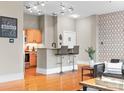 Stylized living room with hardwood floors features a view of the breakfast bar and modern lighting, creating a cozy atmosphere at 404 N Laurel Ave # 18, Charlotte, NC 28204