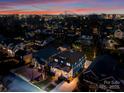Aerial view of a neighborhood highlighting the property's location with city skyline in the background at 448 Iverson Way, Charlotte, NC 28203
