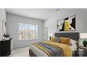Comfortable bedroom featuring neutral tones, artwork, and a large window with natural light at 4710 Lakeview Rd # Lot 10, Charlotte, NC 28216