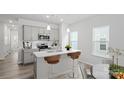 Stylish kitchen with stainless steel appliances, a center island, and a breakfast bar at 4710 Lakeview Rd, Charlotte, NC 28216