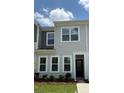 Close-up of gray townhome exterior with well-manicured lawn and inviting entryway at 4710 Lakeview Rd # Lot 10, Charlotte, NC 28216