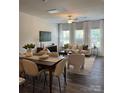 Open-concept living and dining area featuring hardwood floors and modern furnishings at 4710 Lakeview Rd # Lot 10, Charlotte, NC 28216