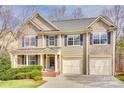 Beautiful two-story home featuring a well-manicured lawn, attached two-car garage and charming front porch area at 6458 Chadwell Ct # 30, Indian Land, SC 29707