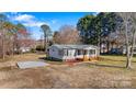 Cozy single-story home surrounded by lush greenery and a spacious, open yard at 8670 Carroll St, Hickory, NC 28601
