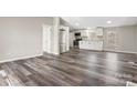 Bright, open-concept living space with modern wood-look floors and neutral wall colors at 8670 Carroll St, Hickory, NC 28601