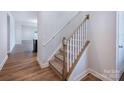 Carpeted staircase with white risers and wood handrail in a bright, modern home interior at 9528 Pointer Rd # 63, Huntersville, NC 28078