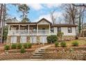 Charming home featuring a stone foundation, brick stairs, and a cozy covered porch with white railings at 10031 Bora Bora Dr, Tega Cay, SC 29708