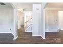 This home features a naturally lit open floor plan with fresh neutral paint, wood floors, and a wooden staircase at 1066 Streamlet Way, Monroe, NC 28110