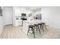 Bright kitchen boasts a central island with bar stool seating, creating a casual dining space at 11205 Cardinal Creek Ave, Charlotte, NC 28215