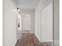 Hallway featuring wood flooring and neutral paint, leading to other rooms in the house at 114 Glen Rae Sw St, Concord, NC 28025