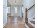 Inviting entryway with hardwood floors, white trim, and a staircase leading to the upper level at 1176 Weir Ct, Fort Mill, SC 29708