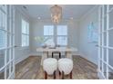Stylish office with a modern desk, decor, wood floors, a chandelier, and plenty of natural light at 1176 Weir Ct, Fort Mill, SC 29708