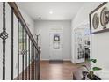 Welcoming foyer with hardwood floors, decorative door, staircase, and adjacent office at 13044 Cottage Crest Ln, Charlotte, NC 28273