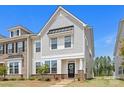 Inviting two-story townhome with a manicured lawn and charming front entrance at 13044 Cottage Crest Ln, Charlotte, NC 28273