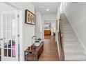 Hallway view with stairs, wood floors, and a view to the living room at 13044 Cottage Crest Ln, Charlotte, NC 28273