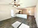 Bright, open-concept living room and kitchen area with modern flooring, lots of natural light, and white cabinets at 1350 Russell St, Rock Hill, SC 29730