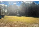 Expansive backyard, partially wooded offering plenty of space for outdoor activities and potential landscaping projects at 14818 Hooks Rd, Matthews, NC 28105