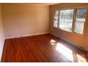Sunlit bedroom showcasing gleaming hardwood floors and a large window at 1610 India Hook Rd # 26, Rock Hill, SC 29732
