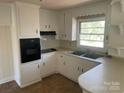 Bright kitchen featuring ample white cabinetry, and modern appliances at 1610 India Hook Rd # 26, Rock Hill, SC 29732