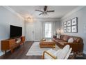 Inviting living room featuring a leather couch, plush ottoman, natural light, and stylish decor at 16619 Spruell St, Huntersville, NC 28078