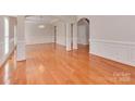 Spacious living room boasts hardwood floors, decorative trim, and ample natural light at 2100 Winding Oaks Trl, Waxhaw, NC 28173